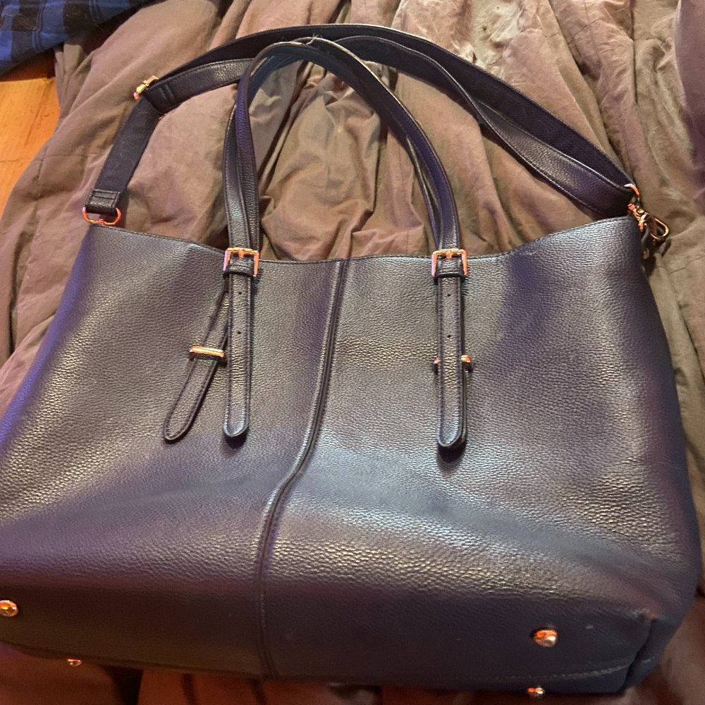 Navy blue laptop bag with lining and pockets, straps and shoulder strap